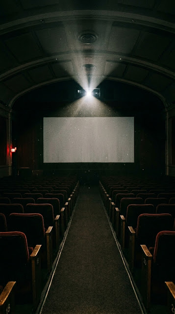 Empty Movie Theater with Projector Light and Floating Dust - Free mobile Wallpaper