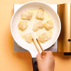 Làm nóng chảo, cho khoảng 5ml dầu ăn vào để chiên cá. Khi dầu nóng thì cho cá đã nhúng bột mì vào chiên. Trở mặt đều để cá vàng giòn. Khi thấy 2 mặt cá vàng đều, gõ vào thấy cứng tức là vỏ bột đã đủ độ giòn rụm, lấy ra đĩa và chờ ráo dầu.