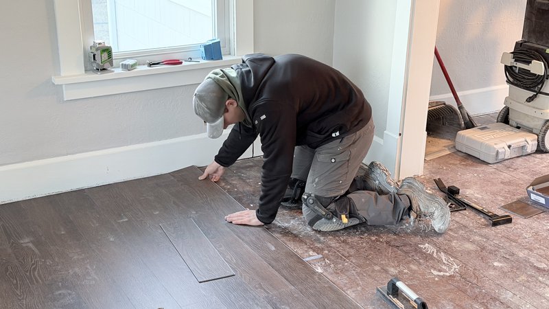 Gavin installing new flooring in a Central Illinois home