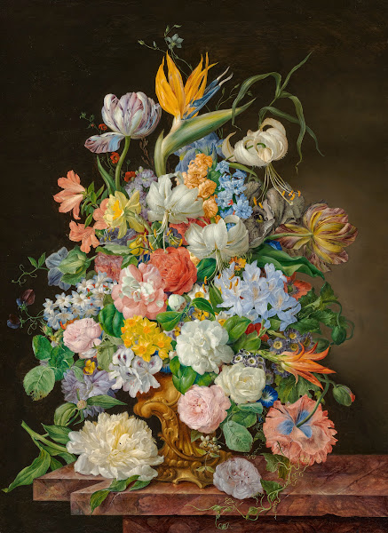 A bird of paradise roses tulips and other flowers in a gilt bronze vase on a sto