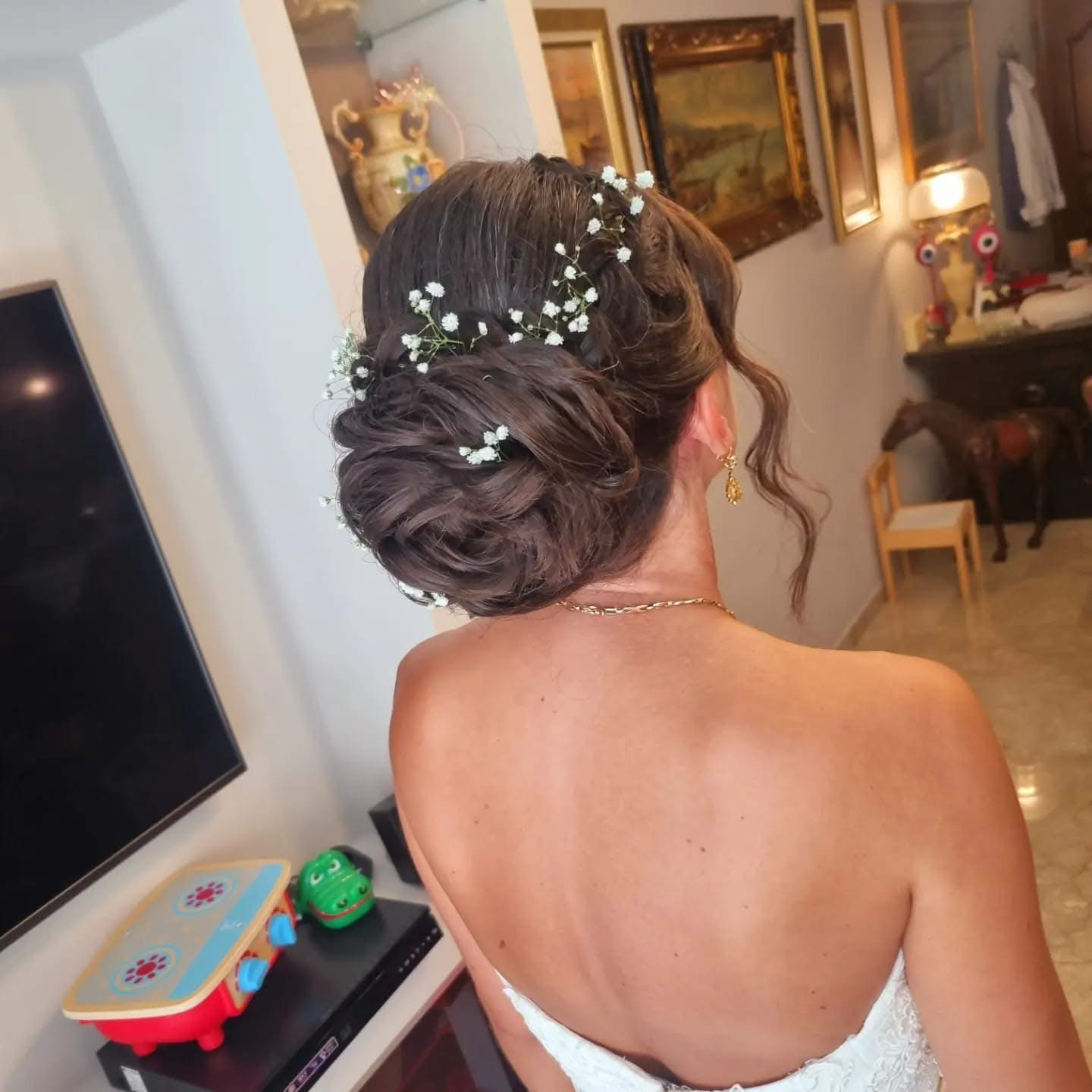Elite bridal styling updo in salon station with flowers