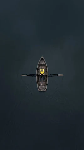 Aerial Top-Down of Solo Kayaker on Dark Water