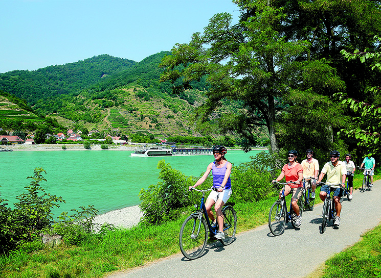 Guests riding bikes along the Danube river