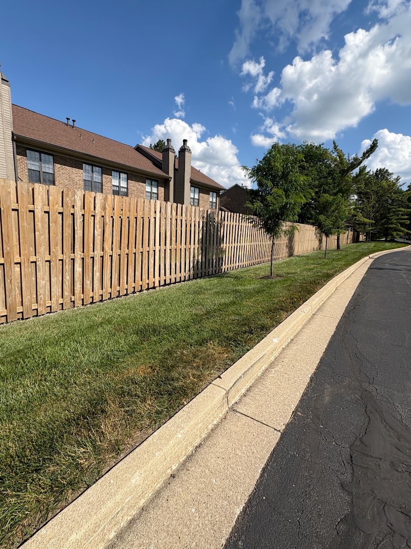 Yardley Court perimeter fence before cleaning and staining, faded natural wood