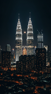 Dramatic Night View of Illuminated Petronas Twin Towers and Moon Over City Skyline