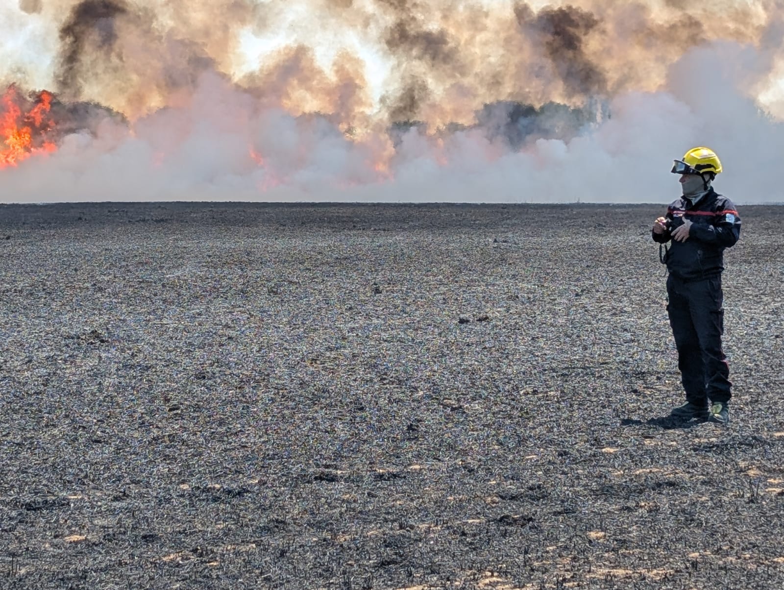 Un sapeur-pompier lutte contre les flammes à la lance à eau
