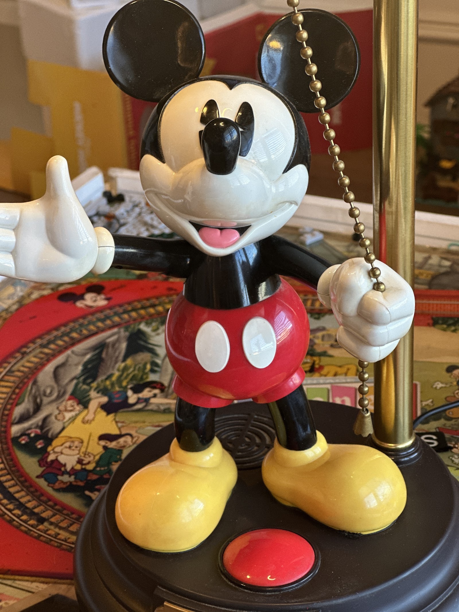 Mickey Mouse animated talking desk lamp by TeleMania, painted resin figure in red shorts and yellow shoes holding pull chain, on circular black base with gold nameplate