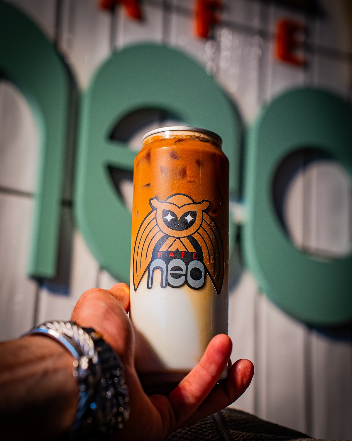 Hand holding iced coffee can — cafe brand photography Hudson Valley