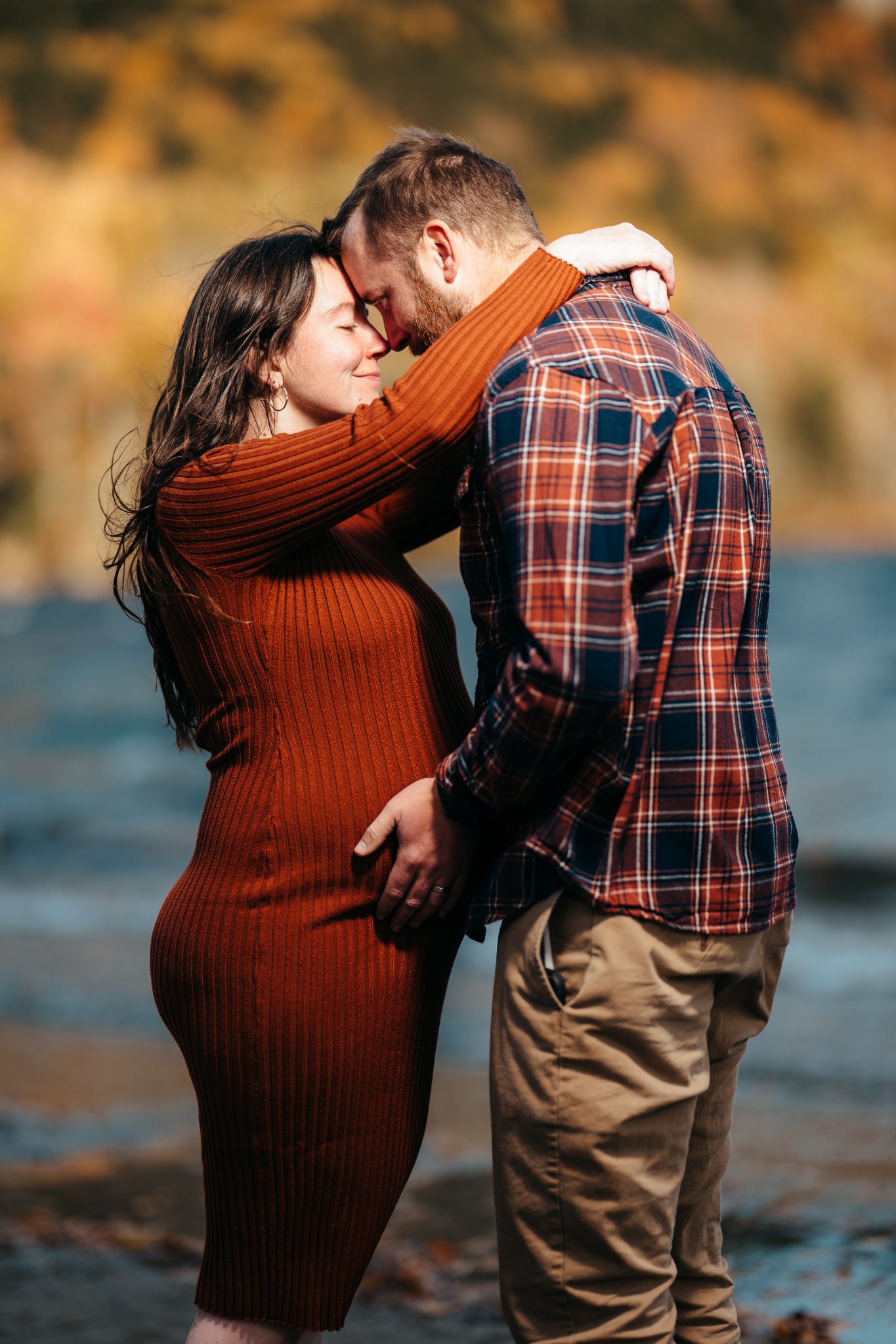 Zack and Holly forehead to forehead, his hand on her bump