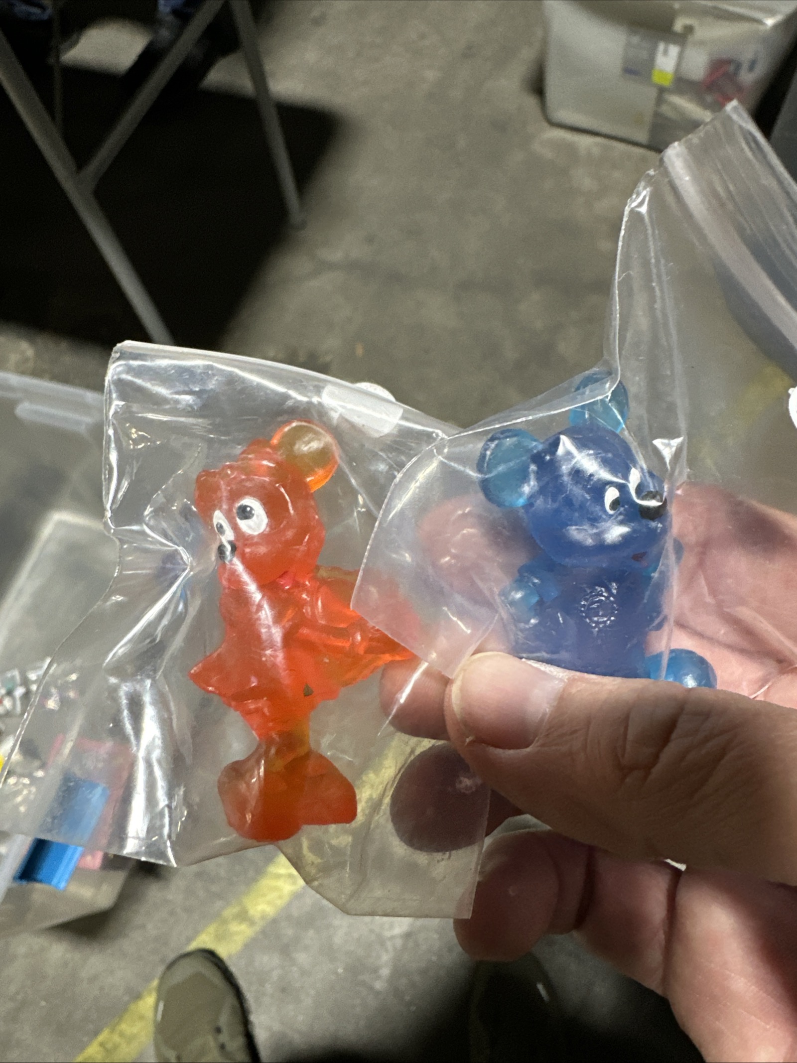 Two translucent Disney gummy bear style figures, one orange and one blue, approximately 2-3 inches tall, shown together against a neutral background
