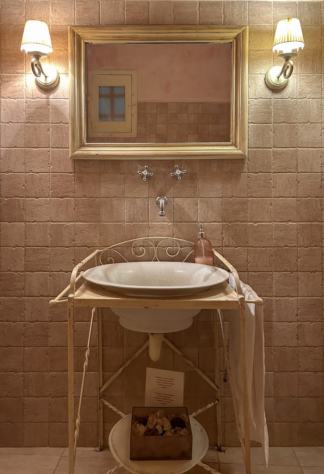 Original stone bathroom at Font de l'Oca retreat — 19th-century terracotta tilework, Catalonia