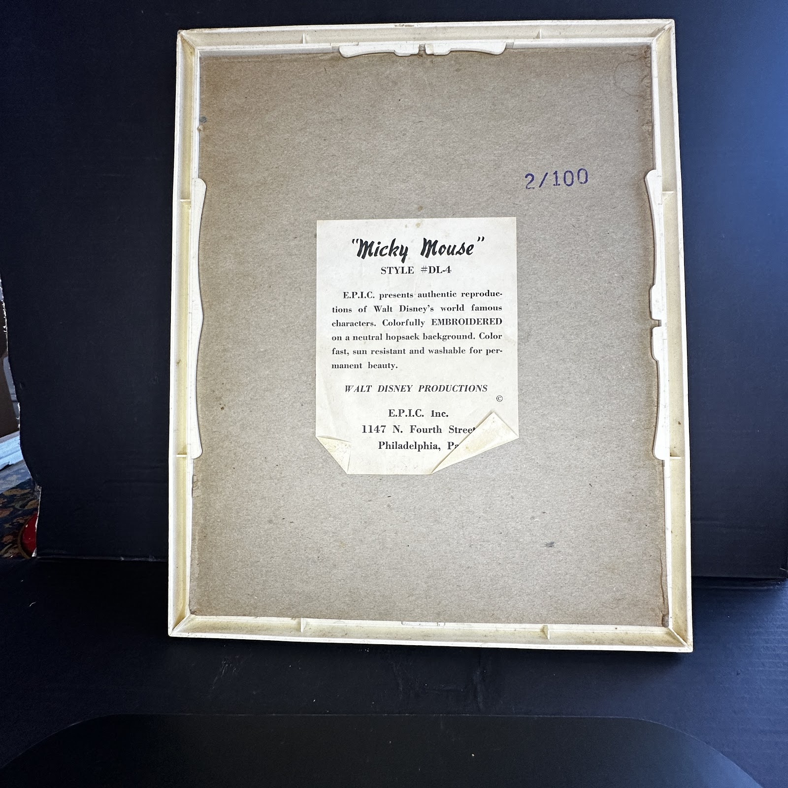 Framed back label of a vintage Mickey Mouse embroidery kit, showing E.P.I.C. Inc. manufacturer text and Walt Disney Productions licensing information
