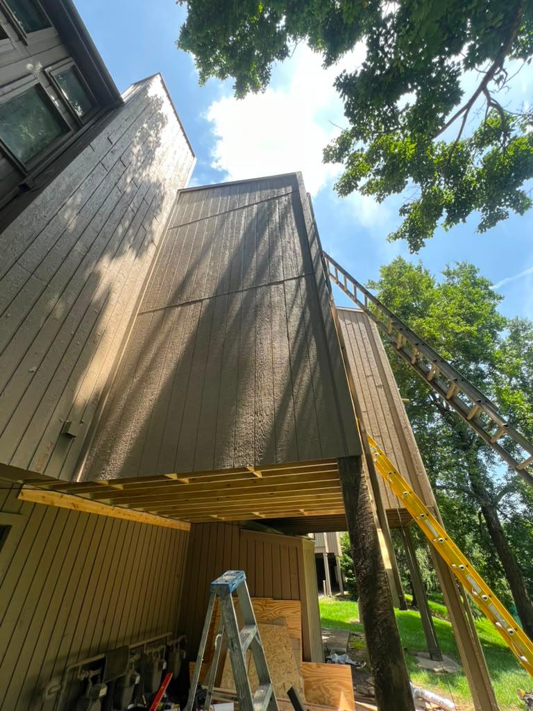 Repainted balcony structure at The Lookout viewed from below, new siding blended with the existing exterior