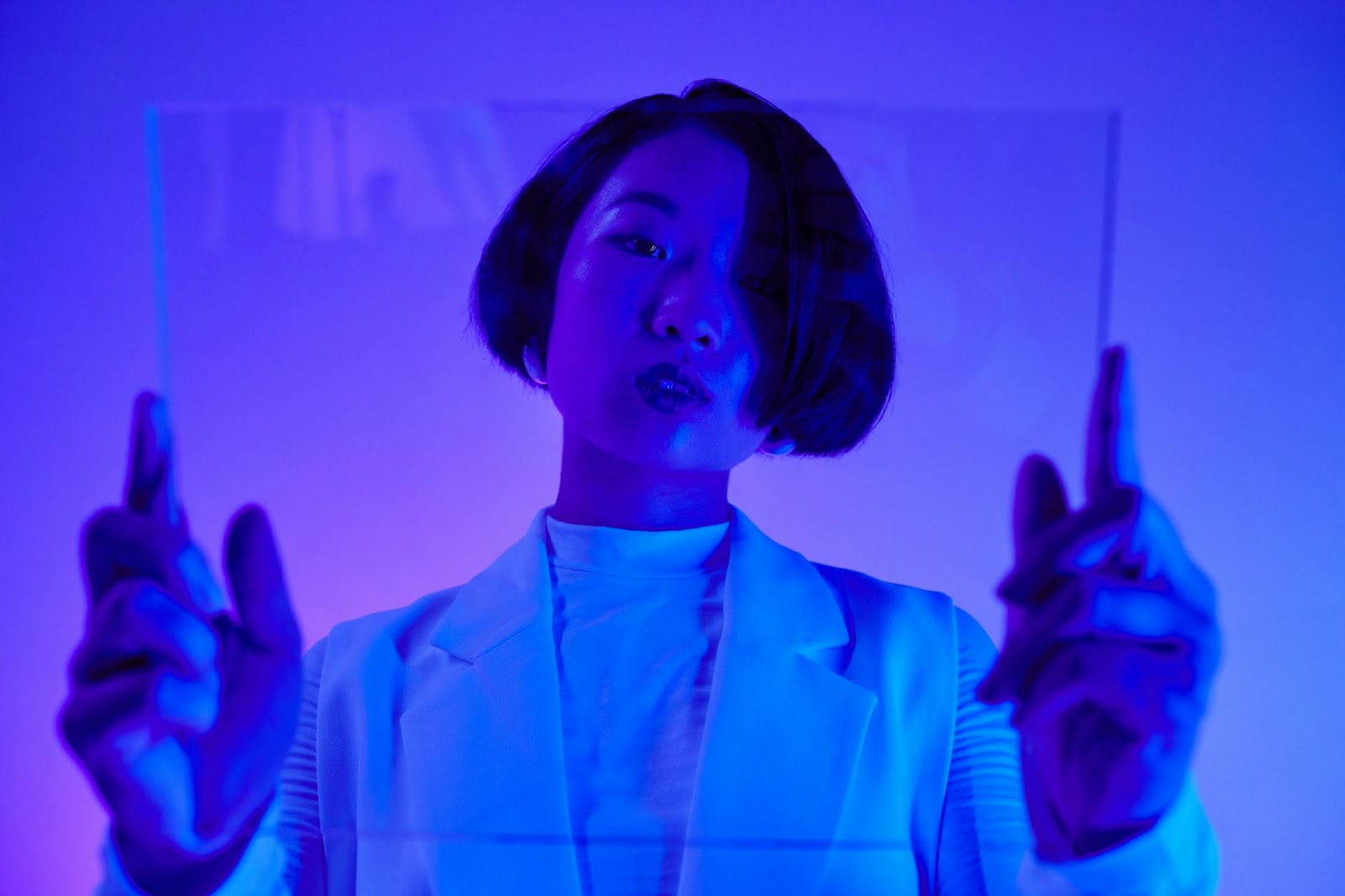 A futuristic fashion studio with holographic displays and biometric scanners, depicting advanced AI virtual try-on fashion.