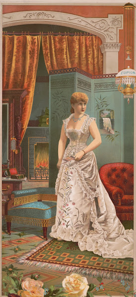 Woman In White Dress Standing Holding A Eupion Oil Brochure With Fireplace And O