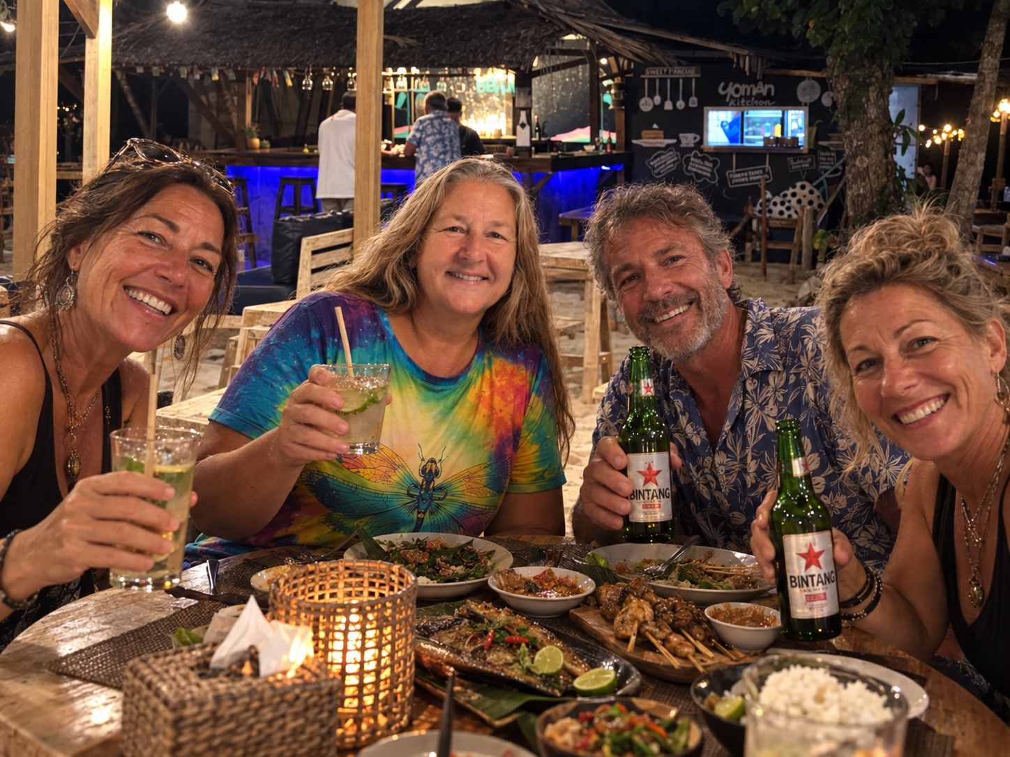 Friends sharing drinks at a beach cafe after hearing the owner's story