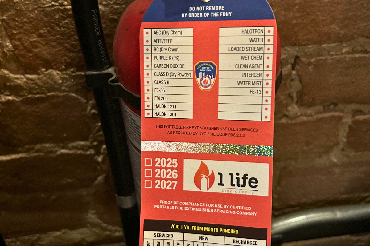 An FDNY portable fire extinguisher service tag, the kind of compliance certification every business in New York already lives with