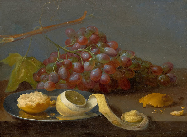 Still life with grapes a lemon and bread on a table