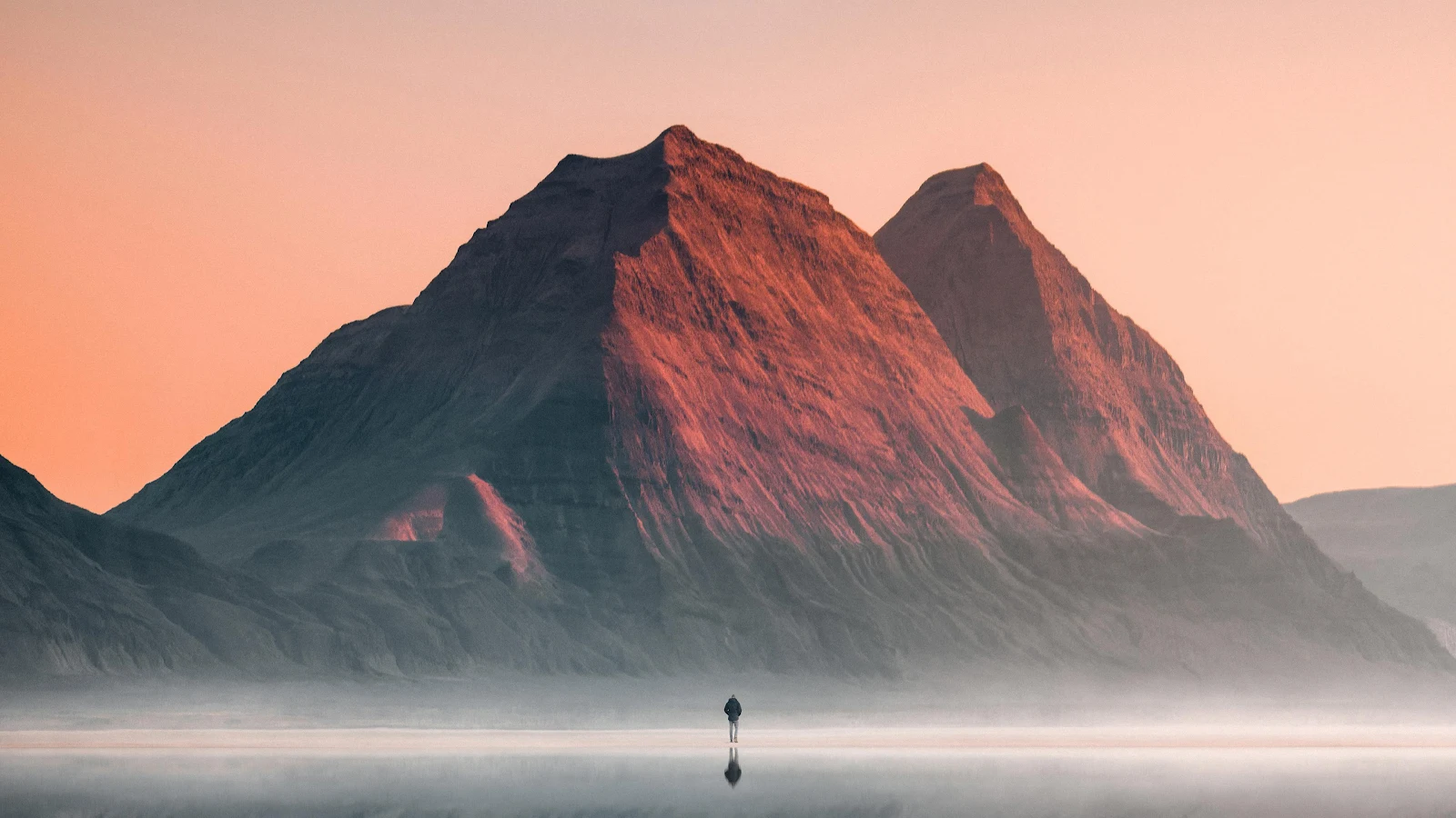 Solitary Walker Under Red Peaks - Dramatic Landscape Photography 4K Wallpaper (3840x2160)