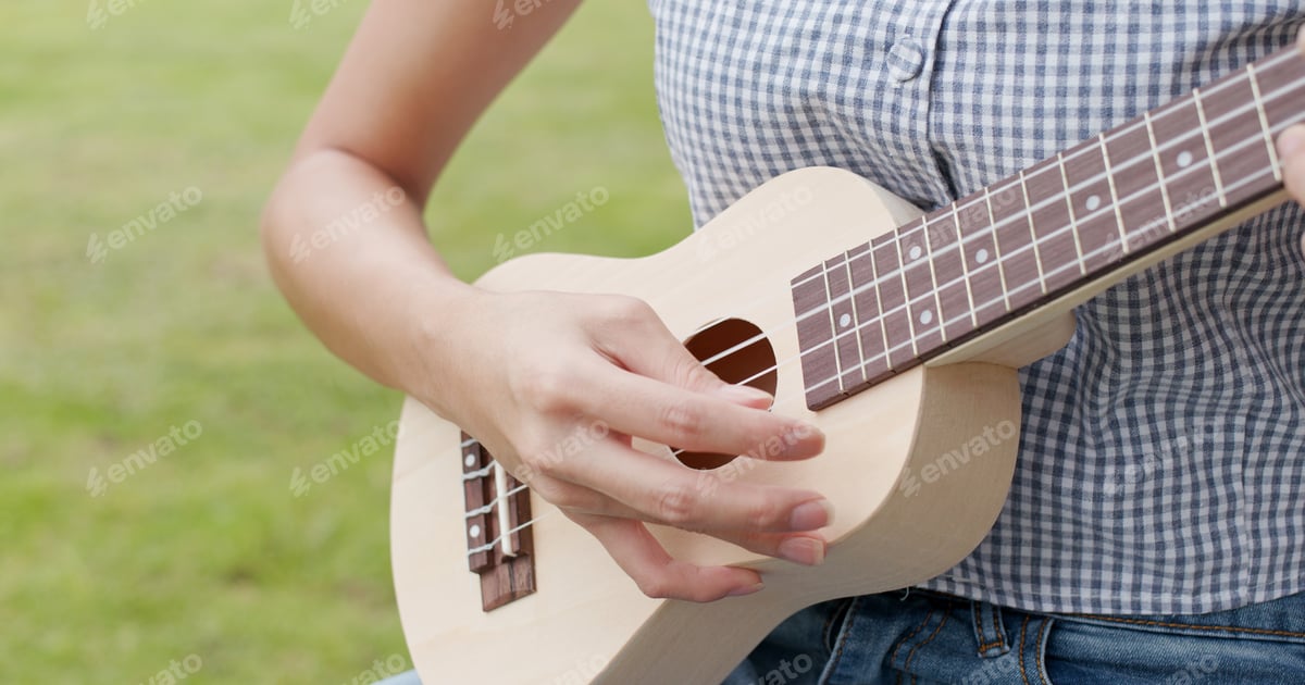 Woman Playing Ukulele in Outdoor Setting Free Download – Envato Elements