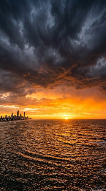 Dramatic Wide Angle Sunset Over Ocean and City Skyline - Free mobile Wallpaper