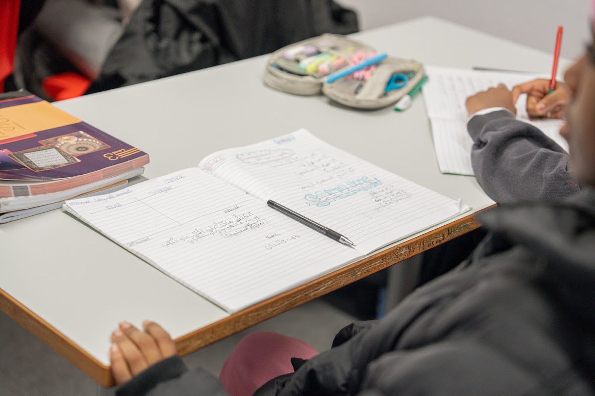 Close-up of student writing in their notebook