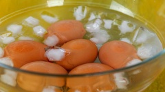 Cho lần lượt 10 quả trứng gà vào nồi nước sôi, thời gian lý tưởng để luộc trứng lòng đào là 6 phút 30 giây. Sau đó, bạn vớt ra cho ngay vào tô nước đá, chờ trứng nguội rồi mới bóc vỏ.