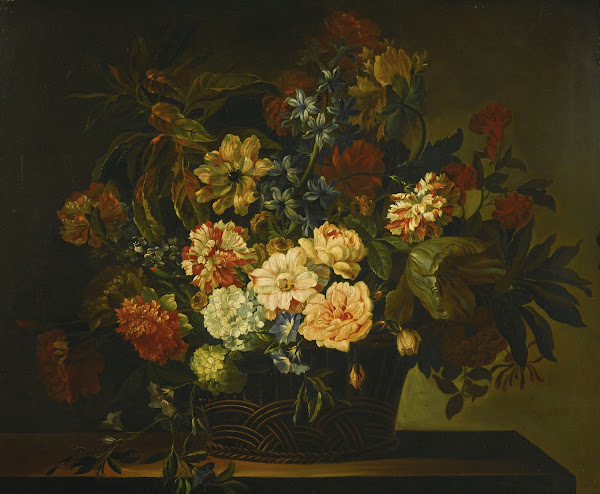 Dahlias Tulips Honeysuckle and other flowers in a basket on a table
