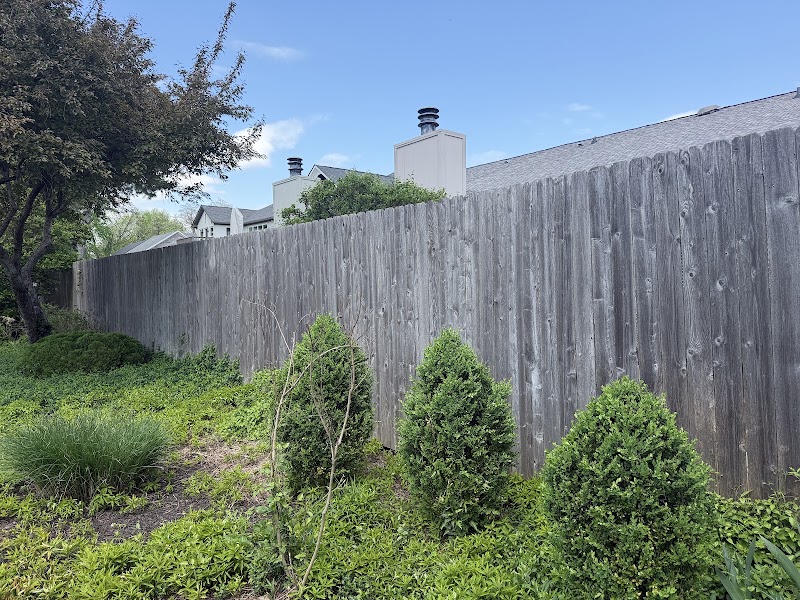 North border fence at Roundtree before staining, bare wood weathered to gray