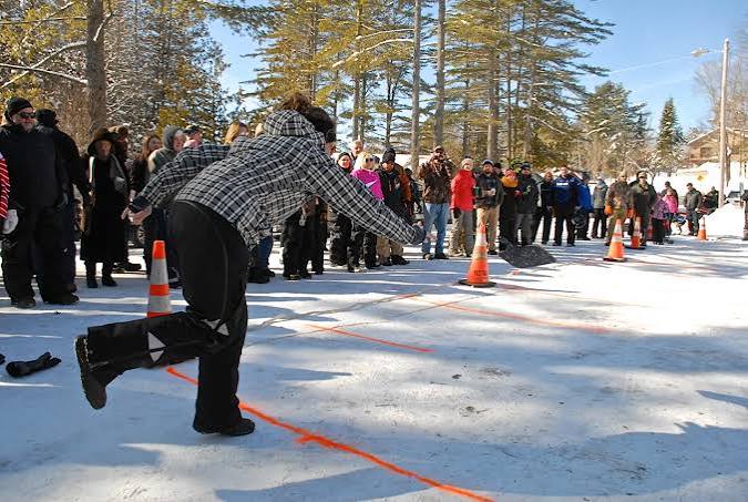 Winter carnival scene on the snow, crowd watching a toss game