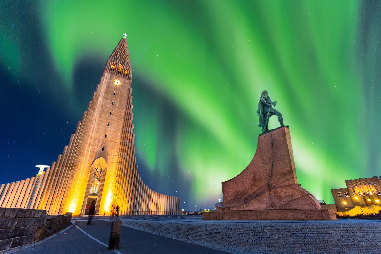 Northern Lights glowing above Hallgrímskirkja Church in Reykjavík, Iceland.