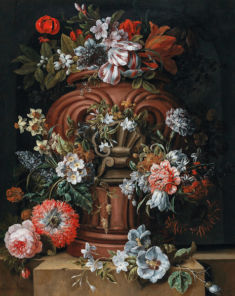 Flowers in a sculpted urn on a stone ledge