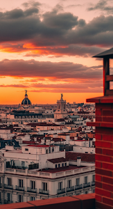 Rooftop View of Madrid Cityscape Silhouette against Fiery Sunset Sky