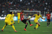 Almoatassim Bellah Hasrati of Libya battles for the ball with Lebogang Mothiba (L) and Kamohelo Mokotjo (R) of South Africa during the 2019 AFCON qualifying match between Libya and South Africa at Stade Taieb Mhiri on March 24, 2019 in Sfax, Tunisia. 