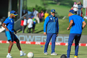 Temba Bavuma (L) plays football with Keshav Maharaj (R) as head coach Mark Boucher watches watches on.    