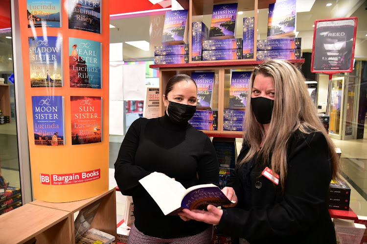 The Herald editor Rochelle de Kock and Bargain Books Walmer Park manager Tracy Terblanche with a a copy of ‘The Missing Sister’ by Lucinda Riley