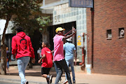 A student fires a sling shot at police, who used a water cannon to disperse protesting students in Braamfontein.