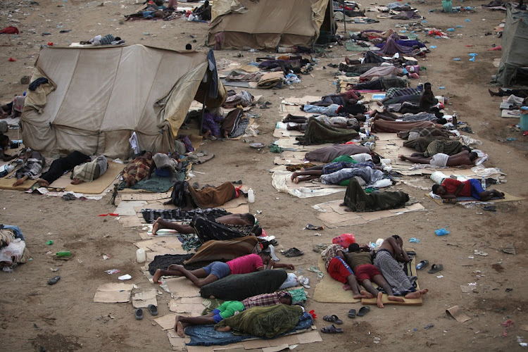 Ethiopian migrants sleep out in the open near a transit centre where they wait to be repatriated, in the western Yemeni town of Haradh. This is a file photo