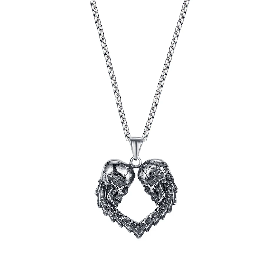 Collier pendentif double tête de mort style Hip Hop en acier titane. Design audacieux et robuste pour hommes. Affirmez votre style avec ce bijou unique.
