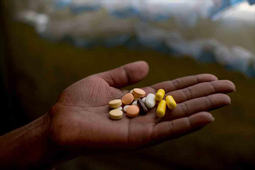 A patient holds her treatment regimen for pre-XDR-TB, which includes delamanid and bedaquiline. Picture: SUPPLIED / Sydelle WIllow Smith