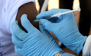 A World Health Organization (WHO) worker administers a vaccination during the launch of a campaign aimed at beating an outbreak of Ebola in the port city of Mbandaka, Democratic Republic of Congo.