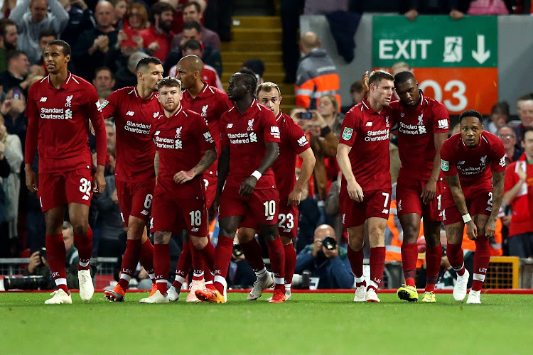 Daniel Sturridge of Liverpool (right) celebrates after he scores his sides first goal during the Carabao Cup Third Round match between Liverpool and Chelsea at Anfield on September 26, 2018 in Liverpool, England.