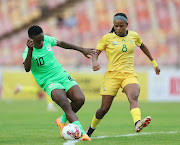 Nigeria player Christy Onyenaturuchi is challenged by Hilda Magaia of South Africa during their Olympic qualifier in Abuja. 