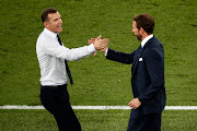 Ukraine coach Andriy Shevchenko shakes hands with his England counterpart Gareth Southgate after the match. 