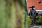 A face mask is seen on a statue as the city operates under lockdown in response to an outbreak of the coronavirus disease (COVID-19) in Melbourne, Australia, August 21 2020. 