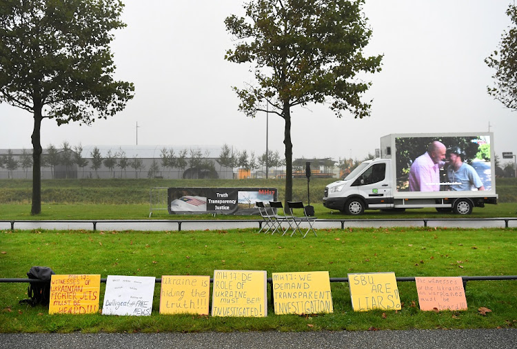 Signs of protesters are seen outside the Schiphol Judicial Complex during a pause in the hearing in the trial of the Malaysia Airlines flight MH17, in Badhoevedorp, Netherlands, September 28, 2020. File photo