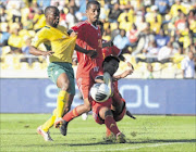 KEPT QUIET: Bafana Bafana striker Siyabonga Nomvethe, left, in a tussel with Ethiopia's Bune Butako Abebaw during their World Cup qualifier clash at Royal Bafokeng Stadium in Rustenburg yesterday.Photo: BackpagePix