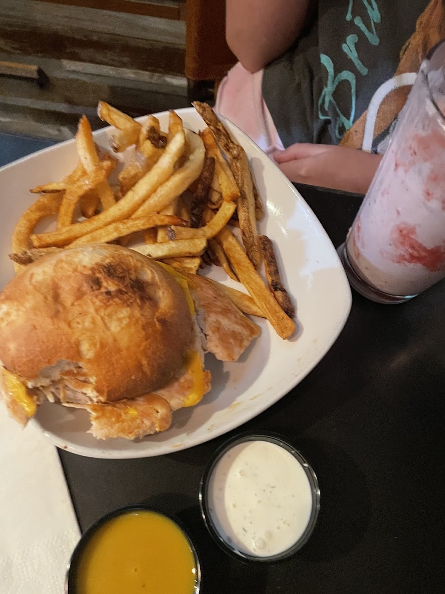 Chicken sandwich on gf bun and fries with a strawberry shake