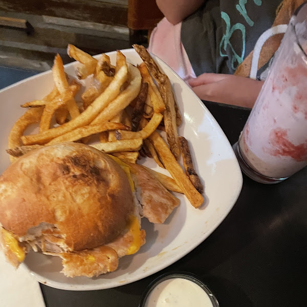 Chicken sandwich on gf bun and fries with a strawberry shake