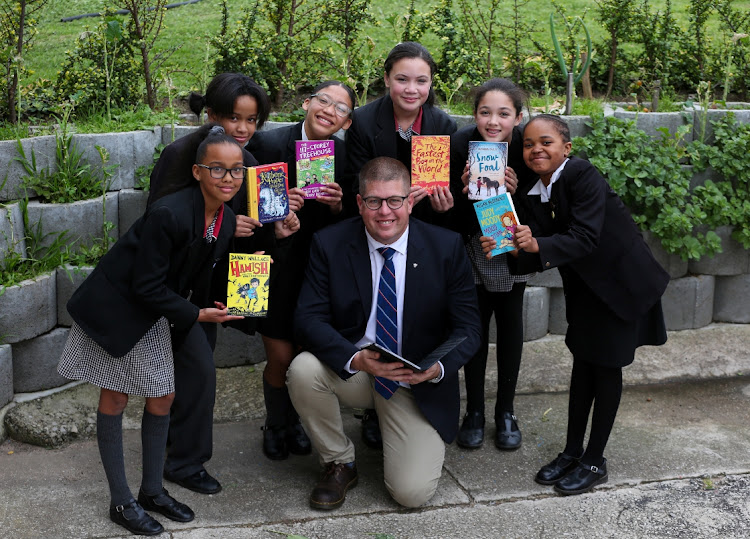 Grey Junior headmaster Grant Butler congratulates the Sanctor Primary School pupils who won the Phendulani Literacy quiz on Wednesday. Pictured from left are Chiandre Harry, 12, Sky-Linn Seymour, 13, Allison Burts,13, Aisha Erasmus,13, Aasiyah Abrahams,11, and Amgoli Ngqungwana,12